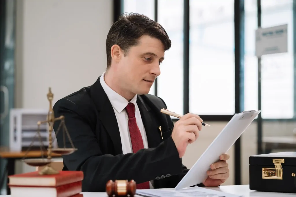 Lawyer reviewing documents in an office with a scale of justice