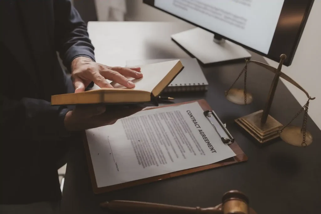 Attorney reviewing a legal contract with scales of justice