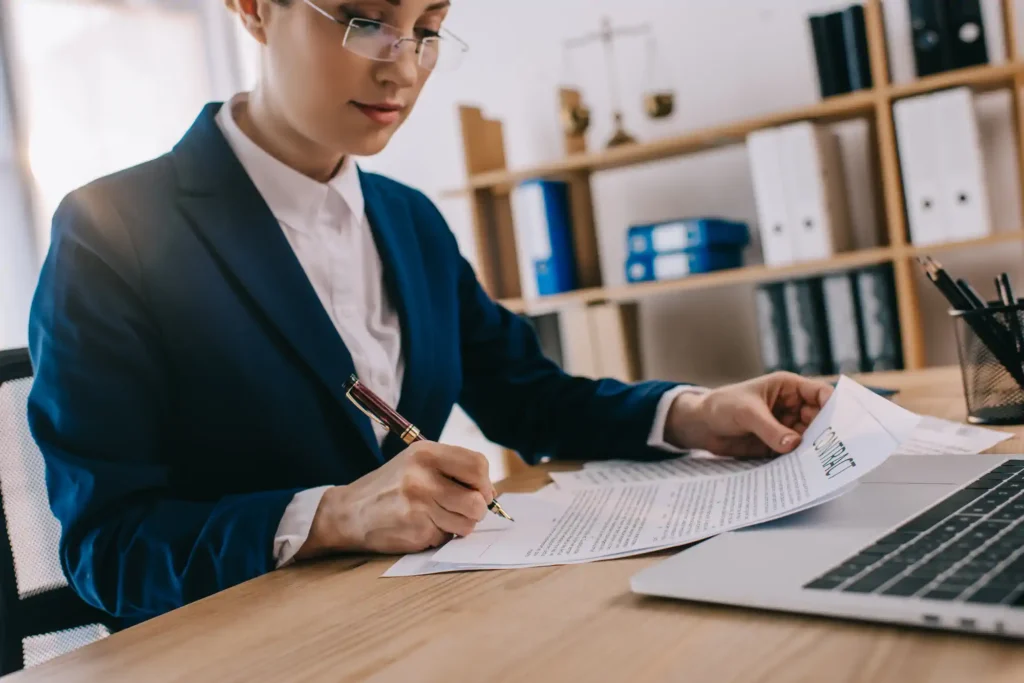 Professional signing a contract at an office desk
